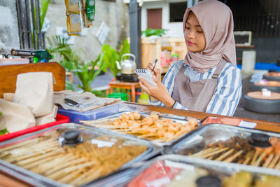 Portrait of woman preparing food at home