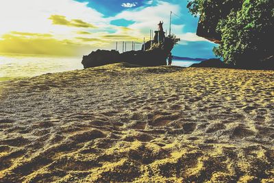 Scenic view of beach against sky during sunset