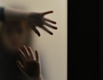 Close-up of hand touching glass at home