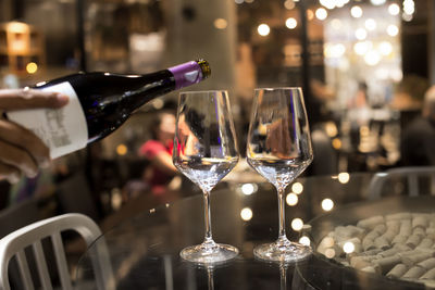 Close-up of wine glasses on table