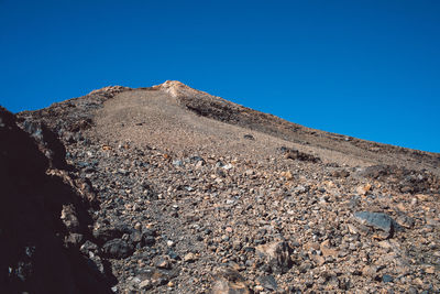 Scenic view of rocky mountains against clear blue sky