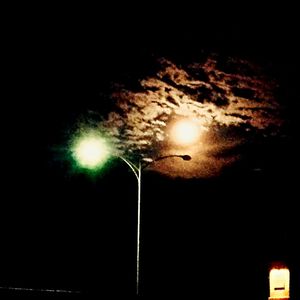 Low angle view of lit lamp post at night