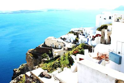 View of town by sea against sky