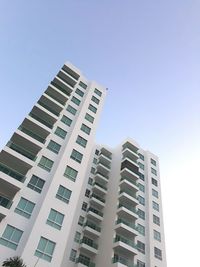 Low angle view of apartment building against clear sky