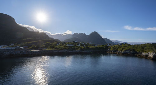 Scenic view of sea and mountains against sky