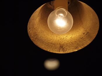 Low angle view of lit lamp