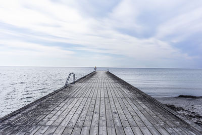 Pier over sea against sky