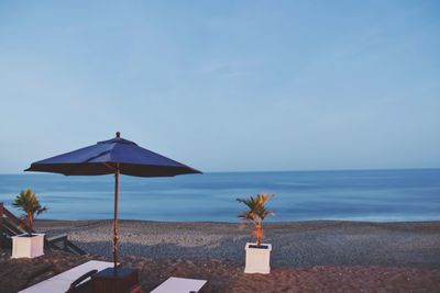 Scenic view of beach umbrella against sky