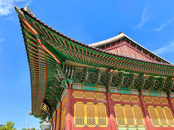 Low angle view of traditional building against blue sky