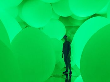 Rear view of silhouette people walking on illuminated balloons