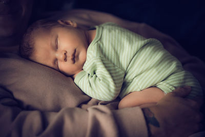 Cute baby sleeping on bed