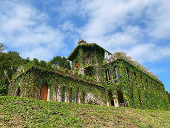 Low angle view of old ruin on field against sky