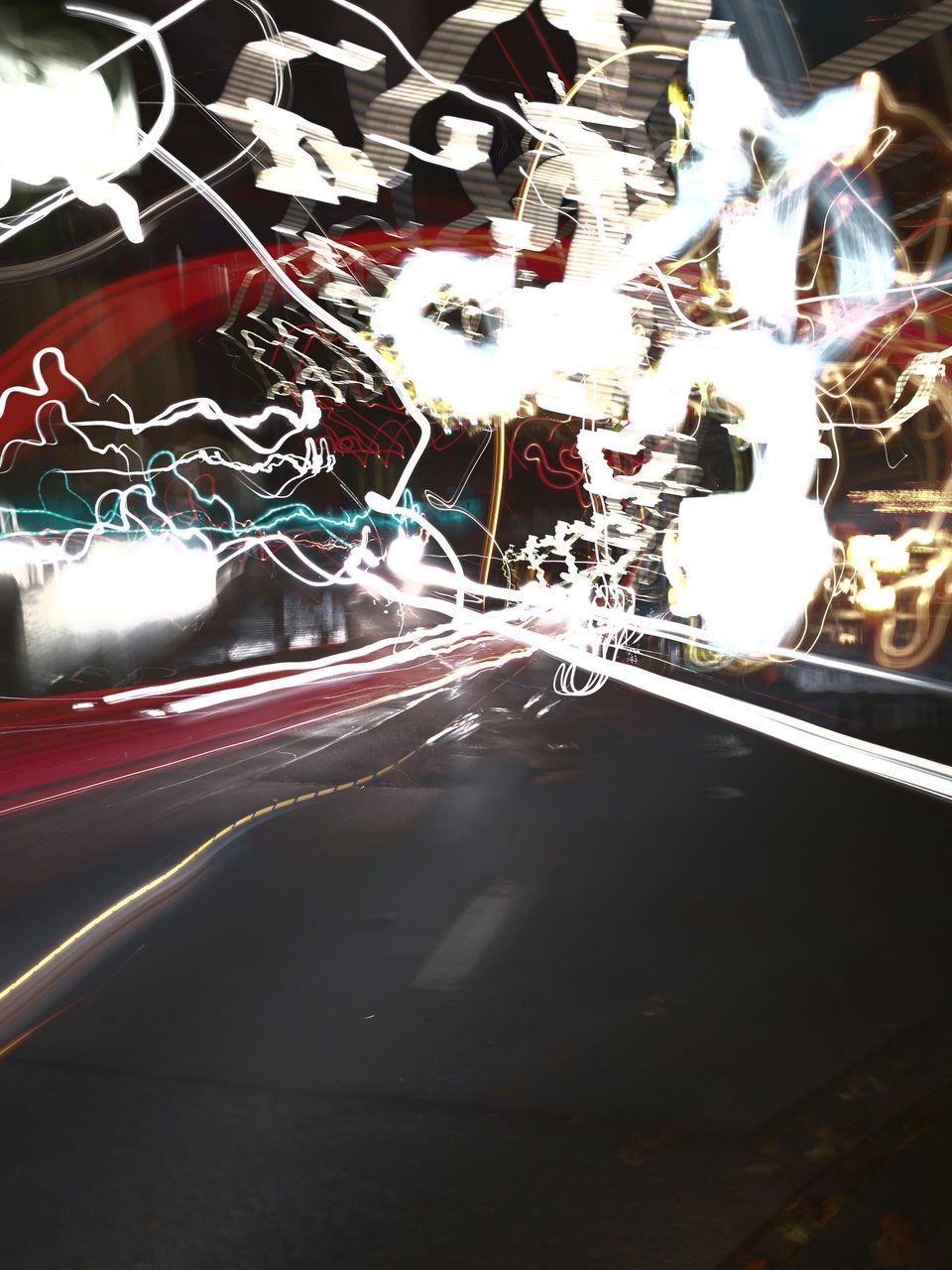 LIGHT TRAILS ON ROAD AT NIGHT