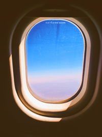 Blue sky seen through airplane window