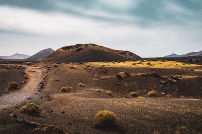 Scenic view of arid landscape against sky