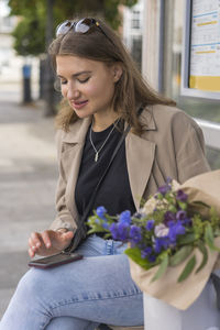 Young woman holding flower bouquet