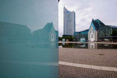 Buildings in city against cloudy sky