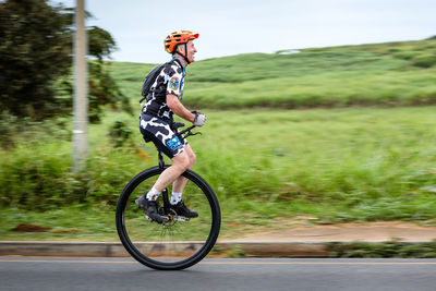 Man riding bicycle on road