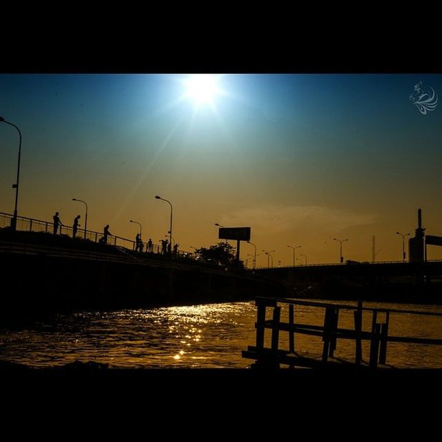 sun, sunbeam, sunlight, lens flare, built structure, water, sunset, sky, transfer print, railing, bright, architecture, pier, sunny, nature, silhouette, tranquility, auto post production filter, scenics, tranquil scene