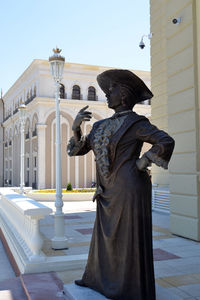 Low angle view of statue against historic building