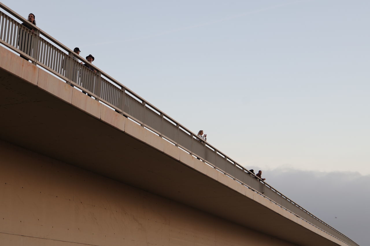 architecture, sky, built structure, line, roof, nature, railing, copy space, low angle view, bridge, day, handrail, adult, outdoors, building exterior, business, men, transportation