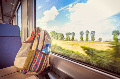 Panoramic view of train against sky seen through car window