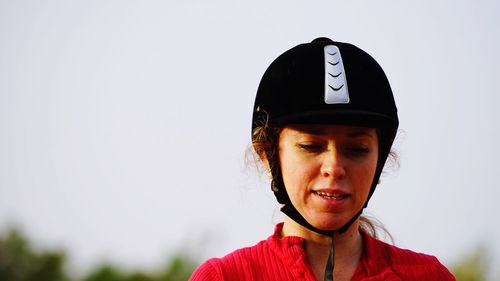 Woman in helmet against clear sky