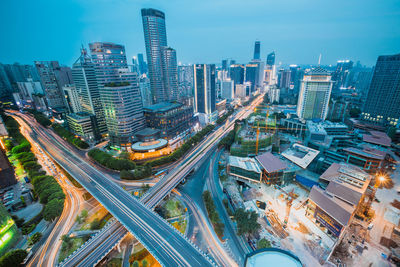 High angle view of city lit up at night