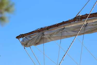 Low angle view of ship mast against clear blue sky