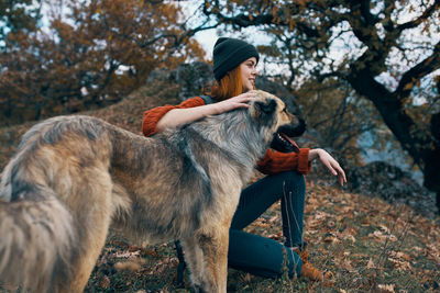 Full length of senior woman with dog