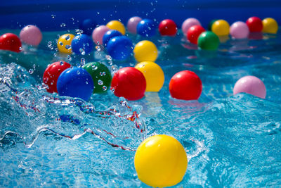 Close-up of multi colored balloons in swimming pool