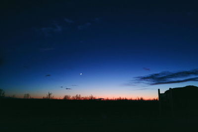 Scenic view of silhouette field against sky at night