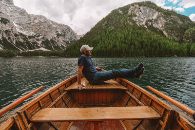 Man sitting on boat at lake 