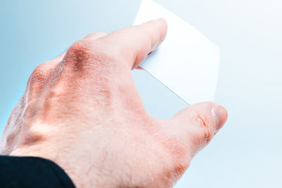 Close-up of hand against white background