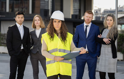 Portrait of business colleagues standing in city