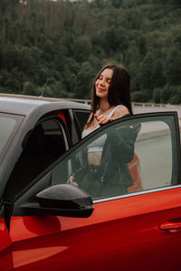 Portrait of young woman in car