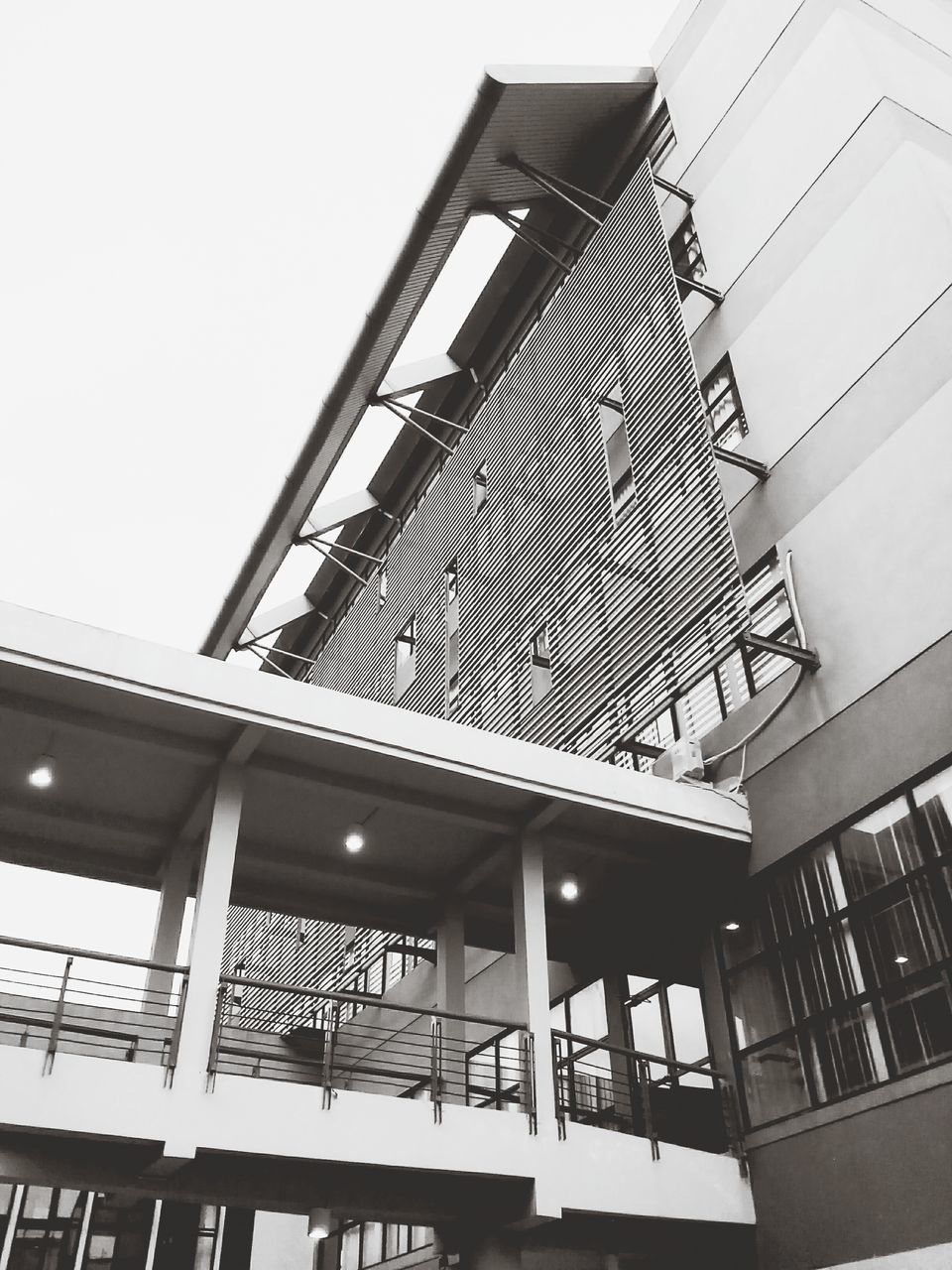 architecture, built structure, low angle view, building exterior, building, clear sky, modern, city, no people, architectural feature, day, residential building, in a row, outdoors, balcony, window, sky, railing, residential structure, repetition