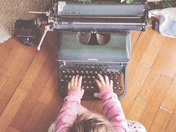 Low section of woman typing with an old typewriter 