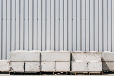 Concrete street barrier in front of wall