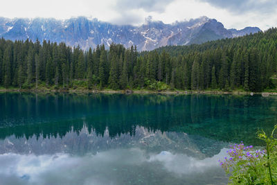 Scenic view of lake by mountains against sky