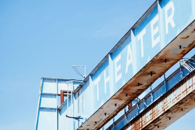 Low angle view of theater building against blue sky