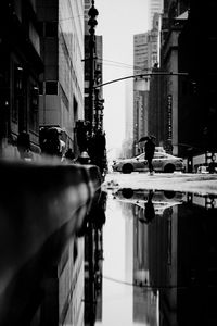 People on street by buildings in city