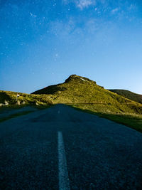 Scenic view of road against sky at night