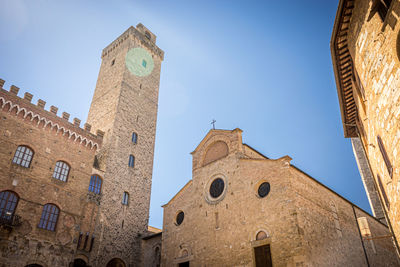 Low angle view of buildings against clear blue sky