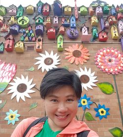 Portrait of smiling boy with multi colored flowers