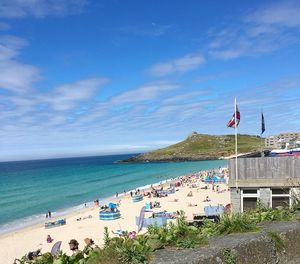 Scenic view of beach against blue sky