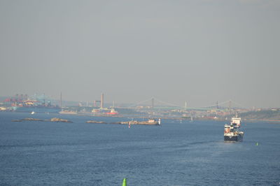 Sailboats in sea against clear sky