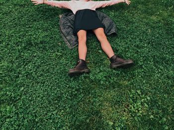 Low section of girl lying on field