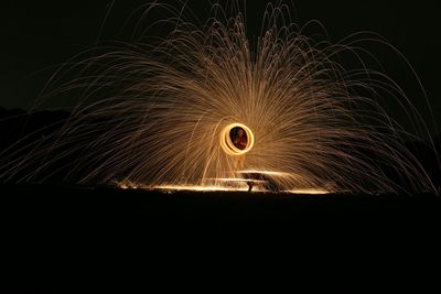 Illuminated ferris wheel in tunnel