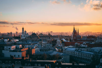 View of buildings in city at sunset